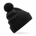 Beechfield's B450N black knit beanie features a pom-pom on top and is displayed at an angle against a white background.