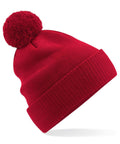A Beechfield red knit beanie with a pom-pom on top, product number B450N.