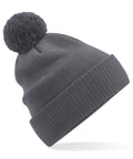 The Beechfield B450N gray knit beanie, featuring a large pom-pom on top, is shown against a white background.