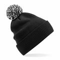 A Beechfield B450R black knit beanie featuring a white and black pom-pom on top.