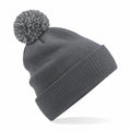 The Beechfield B450R is a gray knit beanie featuring a folded brim and a pom-pom on top.