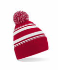 Beechfield's B473R: A knitted beanie in red with white horizontal stripes, featuring a large pom-pom on top.