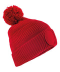 A Beanies red knitted beanie with a large pom-pom and a round front patch, shown against a white background.