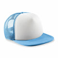 A Beechfield B645B trucker cap featuring a light blue brim and mesh back, complemented by a solid white front panel, rests on a white surface.