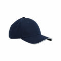 Introducing the B820C by Beechfield: a stylish navy blue baseball cap with a slightly curved brim, adorned with a thin white trim along the edge. This cap features stitching lines that form panels on its crown, set against a plain white background.