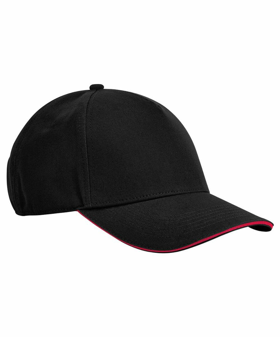A black Beechfield B825C baseball cap with a plain design. The cap features a curved bill with a thin red line along the edge, adding a subtle accent to its overall look. The crown is structured and fitted with a top button.