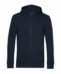 The BA002 from B&C Collection is a black zip-up hoodie featuring a drawstring hood and front pockets, presented against a white background.