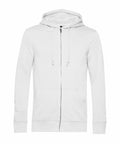 A plain white zip-up hoodie, known as BA002 from B&C Collection, featuring front pockets and adjustable drawstrings.