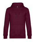 The B&C Collection BA011 is a plain maroon hoodie featuring a front pocket and adjustable drawstrings. It is designed with long sleeves and offers a relaxed fit.