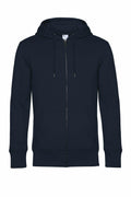 The BA012 by B&C Collection, a plain black zip-up hoodie, is displayed against a white background. It features a drawstring hood and two front pockets.