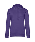The BA01F from B&C Collection is a plain purple hoodie featuring long sleeves, a front pocket, and a drawstring hood, displayed against a white background.