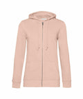 The B&C Collection BA02F is a beige zip-up hoodie featuring a drawstring hood, long sleeves, and front pockets, showcased against a white background.