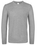 A plain gray long-sleeve T-shirt from the B&C Collection's BA211 line is displayed against a white background. The fabric appears soft and lightweight, showcasing a simple crew neckline with no visible logos or patterns, emphasizing its minimalist design.
