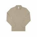 The B&C Collection BA262 is a beige long-sleeve polo shirt featuring a collar and three buttons at the neck, laid flat against a white background, giving it a simple and classic appearance.