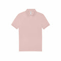 The BA263 by B&C Collection is a plain, light pink polo shirt featuring short sleeves and a collar, displayed against a white background. It includes a button-up neckline with three buttons.