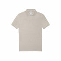 Product BA263 by B&C Collection is a plain beige polo shirt showcasing short sleeves and a classic collar, set against a white background. The shirt is neatly arranged and includes a buttoned placket at the front.