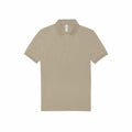 The BA263 by B&C Collection is a plain beige polo shirt featuring a classic collar, short sleeves, and two buttons on the front placket, styled flatly on a white background.