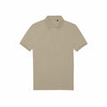 The BA265 by B&C Collection is a plain beige polo shirt featuring short sleeves, a collar, and three buttons. It is presented laid flat against a simple white background.