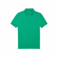 A BA265 polo shirt by B&C Collection, featuring a plain green design with short sleeves and a collar, is shown against a white background.
