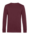 A maroon, long-sleeve crew neck sweatshirt from Sweatshirts is laid flat on a white background.