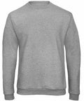 A plain, light gray sweatshirt is displayed against a white background. The B&C Collection BA409 features a crew neck, long sleeves, and ribbed cuffs and hem. The overall design is simple and casual, without any visible logos or designs.