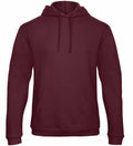 The B&C Collection BA411 is a burgundy hooded sweatshirt featuring a front pocket and drawstrings, set against a plain white background. It boasts a casual, relaxed fit with long sleeves.