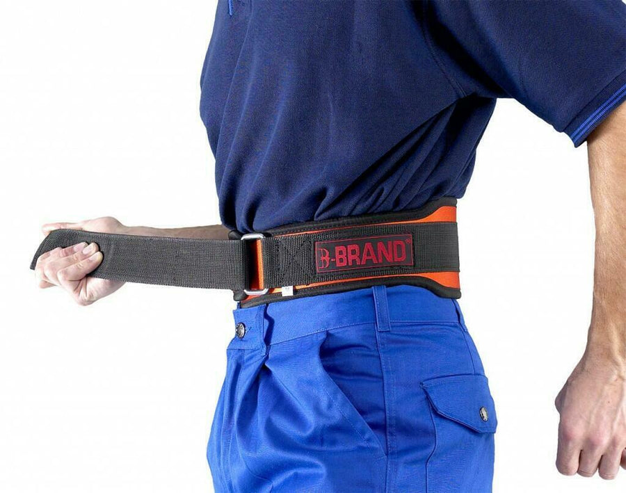 A person wearing blue pants and a navy blue shirt fastens a black lumbar support belt around their waist. The belt has a red logo that says "Beeswift Atlas." The person is shown from the waist down, and the background is plain white.