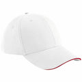 A Beechfield BC020 baseball cap, featuring a plain white design with a red trim along the edge of the brim.