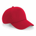 The BC025 by Beechfield is a simple red baseball cap, featuring a curved brim and a top button, shown from a front and slightly angled perspective.