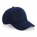 A plain navy blue BC025 baseball cap with a curved brim and button on top from Beechfield, displayed against a white background.