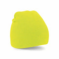 The BC044 knit beanie hat by Beechfield is showcased against a white backdrop. It features a vibrant yellow color, exuding softness and comfort with its classic design that has a slightly slouchy top.