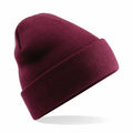 A Beechfield BC045 burgundy knit beanie with a folded brim, floating against a plain white background.
