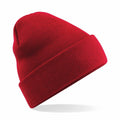 A Beechfield BC045 knit beanie in bright red with a folded cuff is displayed against a plain white background, casting a faint shadow below.