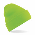 Beechfield BC045 knit beanie in bright green featuring a folded brim, displayed on a white background.