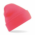 Beechfield's BC045 beanie in vibrant pink, featuring a knit design with a folded brim, is styled at an angle against a white backdrop.