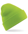 The Beechfield BC045 beanie, shown against a plain white background, features a vibrant green color and a folded cuff. The beanie is slightly tilted to highlight its ribbed texture.