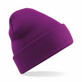 A Beechfield BC045 purple knitted beanie with a folded brim, showcased against a white background.