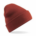 The Beechfield BC045 knit beanie, shown in a vibrant red hue against a white background, is positioned at an angle to emphasize its textured design and folded brim.