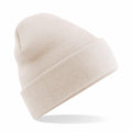 The Beechfield BC045 is a beige knit beanie featuring a folded cuff, showcased at an angle against a white background.