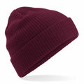 A Beechfield BC050 burgundy knit beanie hat on a white background.