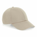 The Beechfield BC054 is a plain beige baseball cap featuring a curved brim and a button on top, presented against a white background.