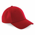 A vibrant red Beechfield BC059 baseball cap featuring a curved brim and adjustable strap is showcased against a simple white backdrop.