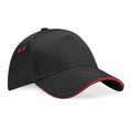 Beechfield's BC15C is a black baseball cap designed with a curved brim, highlighted by red accents along the edge and equipped with two eyelets on each side.