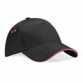 The Beechfield BC15C is a black baseball cap featuring pink detailing on the brim and eyelets.