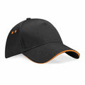 Introducing the Beechfield BC15C: a sleek black baseball cap with stylish orange eyelets and a distinctive orange trim along the brim. This cap features a classic six-panel design and a curved brim for timeless appeal.