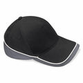 The BC171 by Beechfield is a black baseball cap with a grey brim, highlighted by white piping along the edges. It features a curved visor and side eyelets for ventilation.