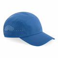 The BC188 baseball cap by Beechfield is designed in blue and features perforated ventilation holes on the side for enhanced breathability. It includes a curved brim with visible stitching.