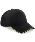 Beechfield BC25C black baseball cap featuring a green trim along the edge of the brim.