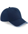 The Beechfield BC25C cap, featuring a navy blue design with a curved visor and white edging along the brim, is displayed against a white background.