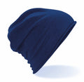 The BC361 beanie from Beechfield is showcased against a white backdrop. This blue hat features a slouchy design, with its soft and stretchy fabric forming gentle folds and curves.